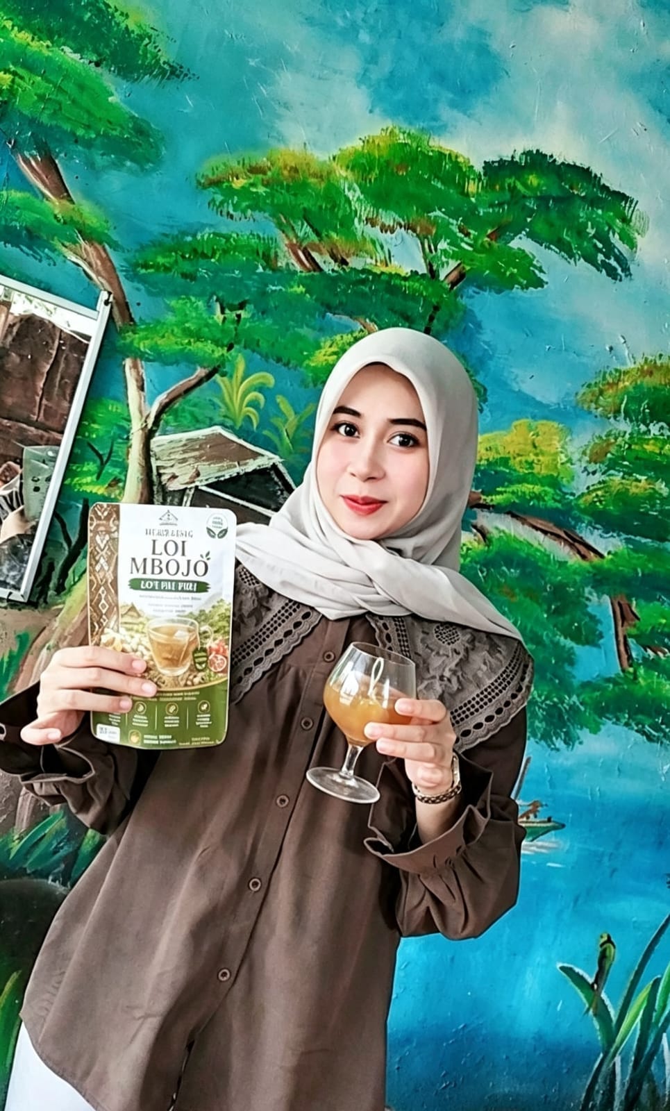 Pemilik produk HERBABAG memperlihatkan kemasan LO'I MBOJO di depan mural